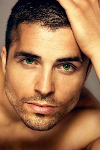 Close up picture of Dane Palmer's face with bright green eyes
